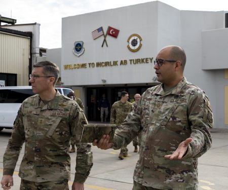 Maj. Gen. John Klein, U.S. Air Force Expeditionary Center commander, left, speaks with Senior Master Sgt. Adrian E. Holguin, 728th Air Mobility Squadron aerial port superintendent, at Incirlik Air Base, Turkey, Feb. 25, 2023.