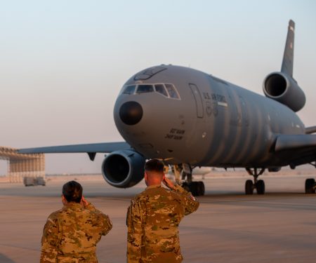 U.S. Airmen salute a KC-10 as it begins to depart after conducting the airframe's final combat deployment at Prince Sultan Air Base (PSAB), Kingdom of Saudi Arabia, Oct. 5, 2023.